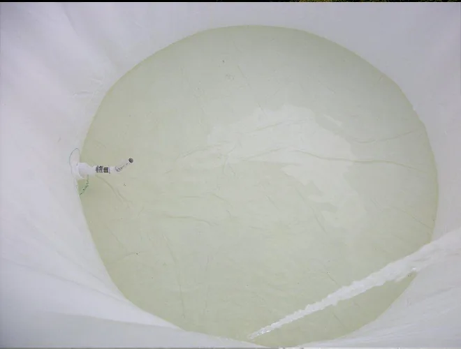 Water beginning to fill the lined tank