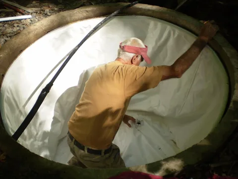 Positioning the white liner inside the concrete tank